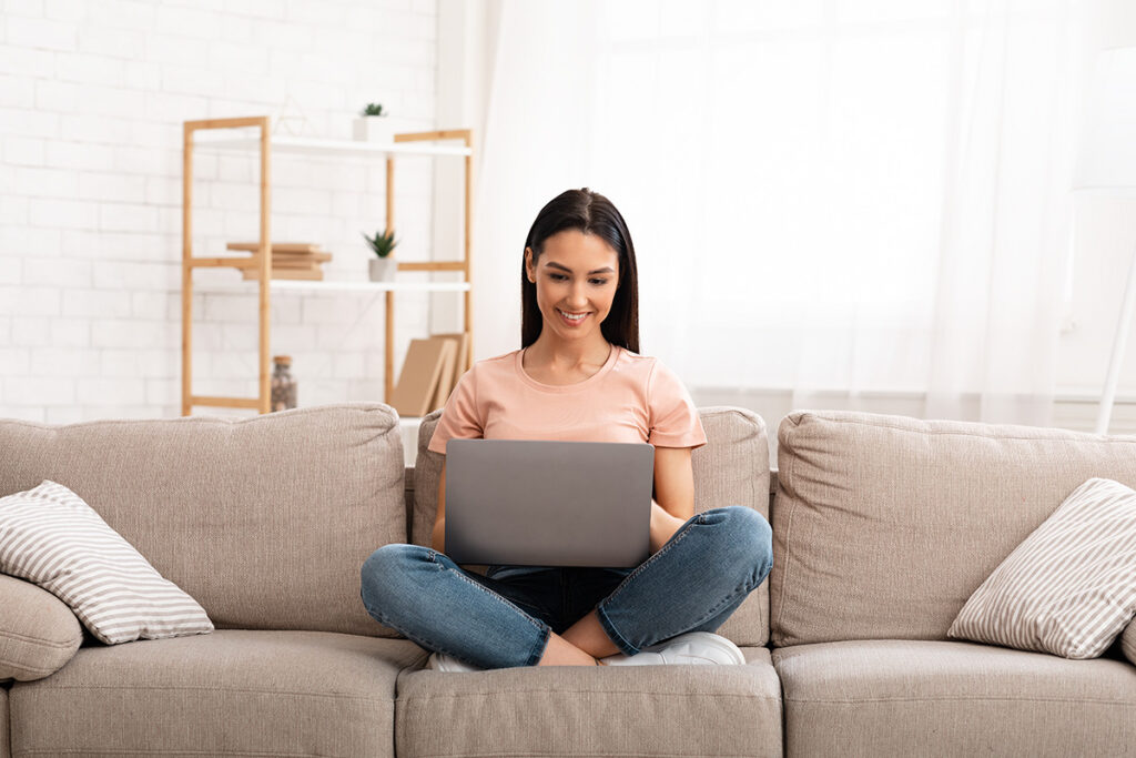 woman plays solitaire on laptop